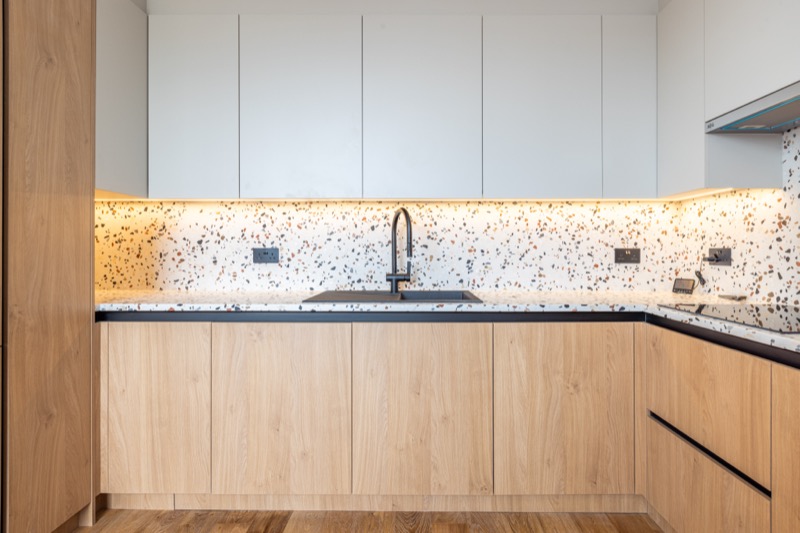 Modern kitchen with terrazzo backsplash and oak cabinetry