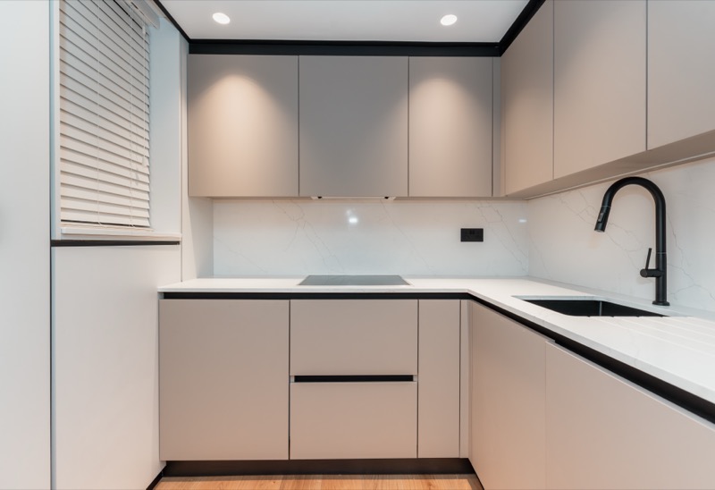 Minimalist beige kitchen with black accents