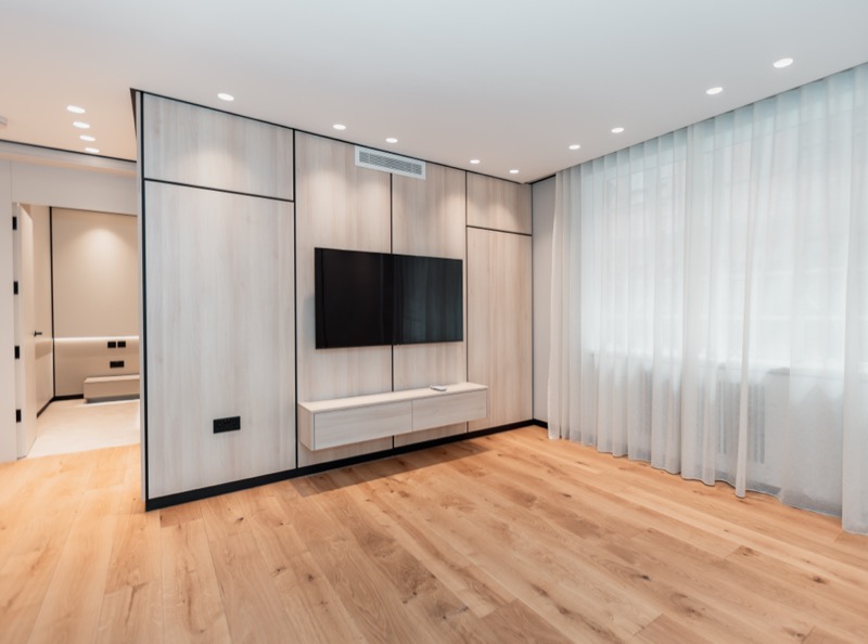 Minimalist living room with wood panel media wall